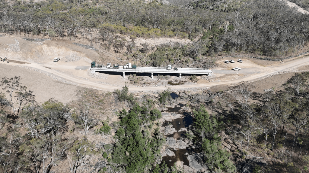Bridge over dry creek with vehicles